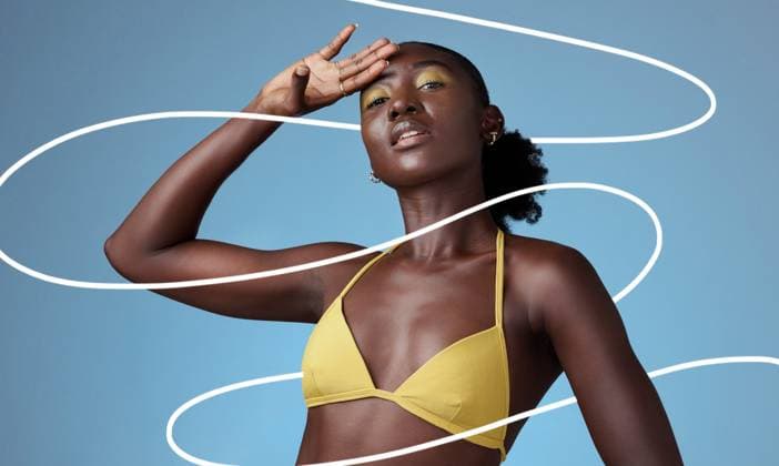 Creative Highlights Symbolfotos Beauty, fashion and makeup with a black woman in studio on a blue background with pattern. Style, cosmetics and design with an attractive young female posing in trendy or contemporary clothes. model released property released Copyright: xwww.peopleimages.comx