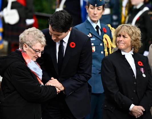 November 11, 2024, Ottawa, On, CAN: Prime Minister Justin Trudeau speaks with Silver Cross Mother Maureen Anderson as assistant deputy speaker Carol Hughes looks on at a Remembrance Day ceremony at the National War Memorial in Ottawa on Monday, Nov. 11, 2024. Ottawa CAN  - ZUMAc35_ 20241111_zaf_c35_014 Copyright: xJustinxTangx