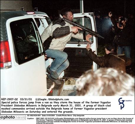 REF:2907- 02 03 31 01 (c)Couple Globalphoto.com Special police forces jump from a van as they storm the house of the former Yugoslav President Slobodan Milosevic in Belgrade early March 31, 2001. A group of black-clad masked commandos arrived outside the Belgrade home of former Yugoslav president Slobodan Milosevic on Saturday and entered the grounds. belgrade  Copyright: xx