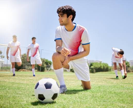 Sports, team and soccer training, stretching and warm up before game competition on field. Young athlete men, fitness workout and football exercise practice or sport lifestyle motivation outdoors. model released property released Copyright: xPeopleImages.comx-x 2543597x