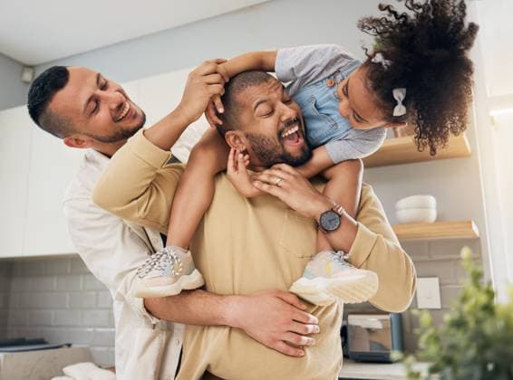 Gay, happy family and playing with child in home or parents together with love, support and girl on shoulders of dad. LGBT, fathers and men with happiness, smile and fun bonding in kitchen with kid. model released property released Copyright: xwww.peopleimages.comx