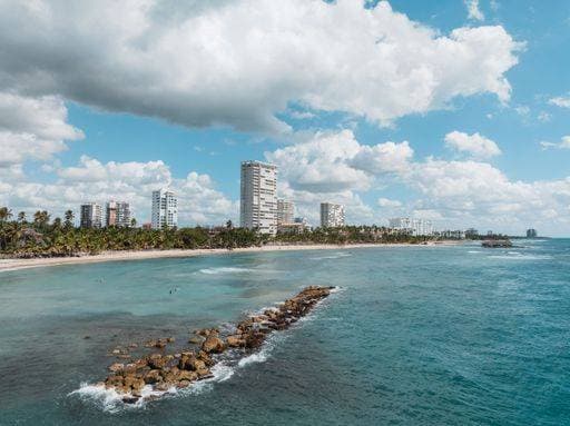 Coastal skyline with modern buildings, palm trees, and a clear blue ocean under a partly cloudy sky in Boca del Rio, Veracruz. 26904564 RECORD DATE NOT STATED