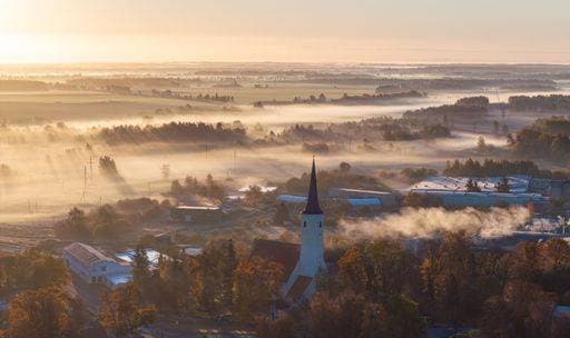 A scenic view of a foggy autumn rural landscape with a church tower in Haljala, Estonia 27262668 RECORD DATE NOT STATED