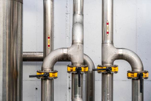 Pipelines, a biogas plant, the gas is produced from various biomass, the electricity is generated in combined heat and power plants with the biogas produced and sold to companies in the neighboring industrial estate, the heat generated is fed into a local heating network, Ense, NRW, Germany, biogas plant