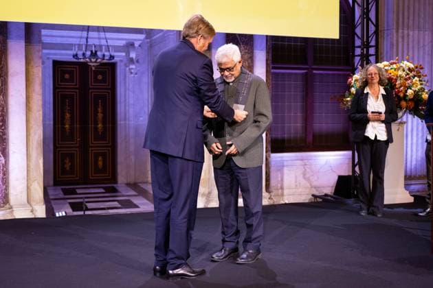 Amsterdam, The Netherlands, 2024-11-26 16:30:39 AMSTERDAM, 26-11-2024, Royal Palace AmsterdamKing Willem Alexander presents the Erasmus Prize to Indian writer Amitav Ghosh (Kolkata, 1956) at the Royal Palace Amsterdam. The King is a patron of the Praemium Erasmianum foundation. PHOTO: NLBeeld Patrick van Emst Credit: NL Beeld Patrick van Emst  Copyright: xx x