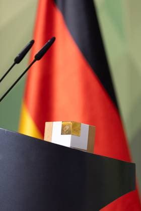 28 11 2024, Bundeswehr and Society Prize Award ceremony 2024 in the Paul Löbe House of the German Bundestag in Berlin Lectern with prize, behind it the German flag Berlin