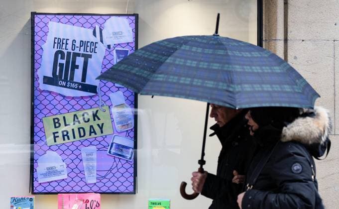 November 29, 2024, Montreal, Pq, CANADA: Signs on storefronts advertise deals as shoppers walk past on Black Friday in Montreal on Friday, Nov. 29, 2024. Montreal CANADA  - ZUMAc35_ 20241129_zaf_c35_021 Copyright: xChristinnexMuschix