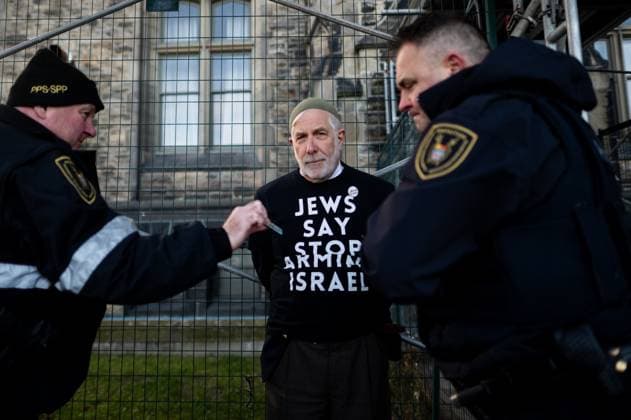 December 3, 2024, Ottawa, On, Canada: A Pro-Palestinian protester is detained by an officer from the Parliamentary Protective Service outside of Confederation Building near Parliament Hill during a sit-in styled protest calling for an arms embargo against Israel in Ottawa, on Tuesday, Dec. 3, 2024. Ottawa Canada  - ZUMAc35_ 20241203_zaf_c35_005 Copyright: xSpencerxColbyx
