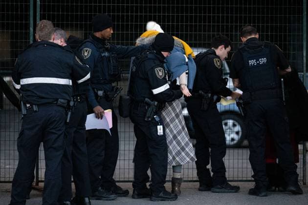 December 3, 2024, Ottawa, On, Canada: A Pro-Palestinian protester has their handcuffs adjusted by an officer from the Parliamentary Protective Service outside of the Confederation Building near Parliament Hill during a sit-in styled protest calling for an arms embargo against Israel in Ottawa, on Tuesday, Dec. 3, 2024. Ottawa Canada  - ZUMAc35_ 20241203_zaf_c35_007 Copyright: xSpencerxColbyx