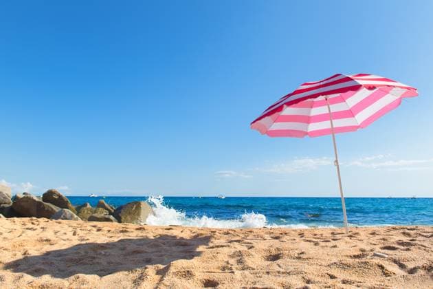 Beach with parasol Empty beach with waves, sea and striped pink parasol Copyright: xZoonar.com IvonnexWierinkx 12941551