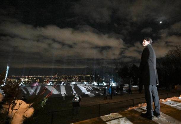 December 6, 2024, Montreal, Pq, Canada: Prime Minister Justin Trudeau looks towards beams of light projected into the sky following a ceremony to honour the victims of the 1989 Polytechnique massacre in Montreal, Friday, December 6, 2024. Today marks the 35th anniversary of the shooting rampage that left 14 women dead. Montreal Canada  - ZUMAc35_ 20241206_zaf_c35_083 Copyright: xGrahamxHughesx