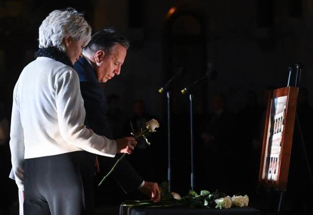 December 6, 2024, Montreal, Pq, Canada: Quebec Premier Francois Legault and wife Isabelle Brais place white roses on a table during a ceremony to honour the victims of the 1989 Polytechnique massacre in Montreal, Friday, December 6, 2024. Today marks the 35th anniversary of the shooting rampage that left 14 women dead. Montreal Canada  - ZUMAc35_ 20241206_zaf_c35_085 Copyright: xGrahamxHughesx