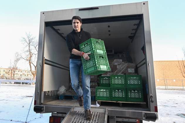 December 7, 2024, Montreal, Pq, Canada: Prime Minister Justin Trudeau helps to unload crates of milk from a truck which will be used to make Christmas baskets during a community event in Montreal, Saturday, December 7, 2024. Montreal Canada  - ZUMAc35_ 20241207_zaf_c35_020 Copyright: xGrahamxHughesx
