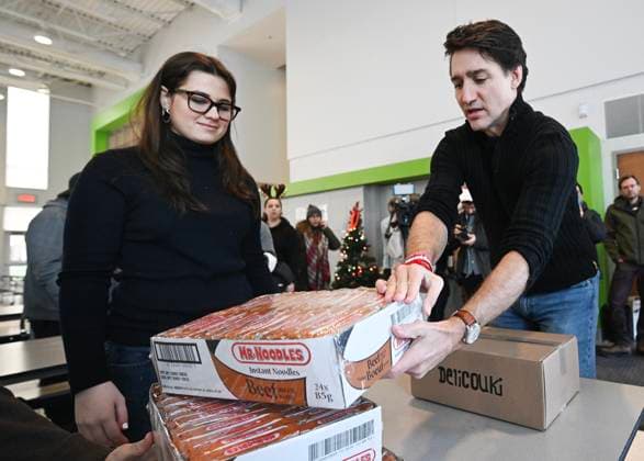 December 7, 2024, Montreal, Pq, Canada: Prime Minister Justin Trudeau places boxes of noodles on a table which will be used to make Christmas baskets during a community event in Montreal, Saturday, December 7, 2024. Montreal Canada  - ZUMAc35_ 20241207_zaf_c35_021 Copyright: xGrahamxHughesx