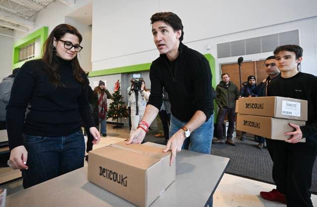 December 7, 2024, Montreal, Pq, Canada: Prime Minister Justin Trudeau places a box of food items on a table which will be used to make Christmas baskets during a community event in Montreal, Saturday, December 7, 2024. Montreal Canada  - ZUMAc35_ 20241207_zaf_c35_022 Copyright: xGrahamxHughesx