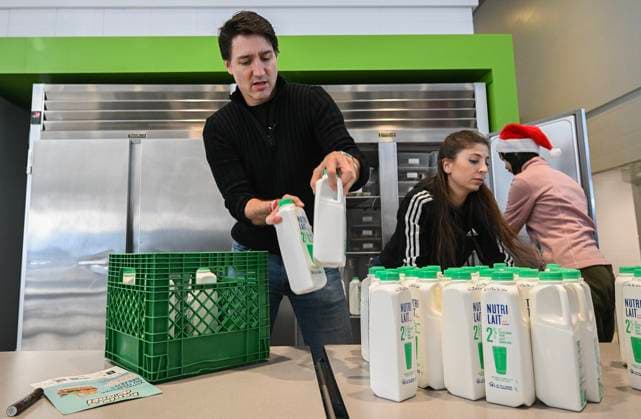 December 7, 2024, Montreal, Pq, Canada: Prime Minister Justin Trudeau helps to refrigerate milk which will be used to make Christmas baskets during a community event in Montreal, Saturday, December 7, 2024. Montreal Canada  - ZUMAc35_ 20241207_zaf_c35_024 Copyright: xGrahamxHughesx