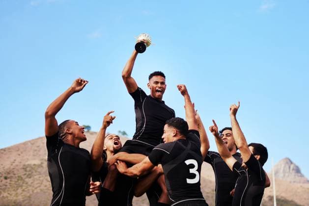 Creative Highlights Symbolfotos Men, celebrate and rugby ball for energy, outdoor or challenge with exercise, wellness and fitness. Male people, game and recreation facility as winner for team, sports or success in stadium or arena. model released property released Copyright: xwww.peopleimages.comx