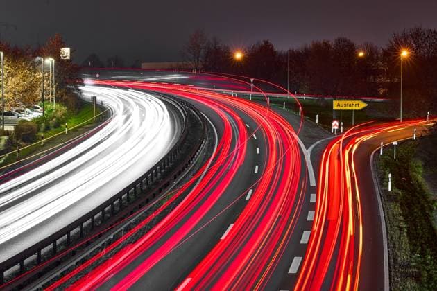 Augsburg, Bavaria, Germany - December 12, 2024: Long exposure of the federal highway B17 near Augsburg with luminous light trails of the vehicles and a clearly visible exit sign at night *** Langzeitbelichtung der Bundesstraße B17 bei Augsburg mit leuchtenden Lichtspuren der Fahrzeuge und einer gut sichtbaren Ausfahrtbeschilderung bei Nacht