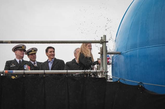 December 13, 2024, North Vancouver, Bc, CANADA: HMCS Protecteur ship sponsor Teri McKinnon, right, breaks a bottle of champagne on the bow of the new Royal Canadian Navy Joint Support vessel as HMCS Protecteur captain Landon Creasy, from left to right, Royal Canadian Navy Commander, vice-admiral Angus Topshee and Prime Minister Justin Trudeau watch, during a launch and naming ceremony at Seaspan Shipyards, in North Vancouver, B.C., on Friday, December 13, 2024. The ship is scheduled to be delivered to the Royal Canadian Navy in 2025. North Vancouver CANADA - ZUMAc35_ 20241213_zaf_c35_086 Copyright: xDarrylxDyckx