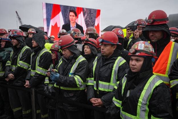 December 13, 2024, North Vancouver, Bc, CANADA: Prime Minister Justin Trudeau is seen on a video screen while speaking as workers listen during a launch and naming ceremony for the new Royal Canadian Navy Joint Support vessel HMCS Protecteur, at Seaspan Shipyards in North Vancouver, B.C., on Friday, December 13, 2024. The ship is scheduled to be delivered to the Royal Canadian Navy in 2025. North Vancouver CANADA  - ZUMAc35_ 20241213_zaf_c35_094 Copyright: xDarrylxDyckx