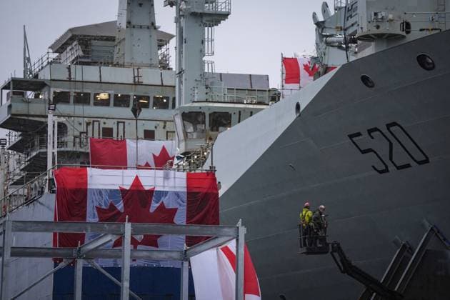 December 13, 2024, North Vancouver, Bc, CANADA: Workers are seen on a lift beside the new Royal Canadian Navy Joint Support vessel before a launch and naming ceremony at Seaspan Shipyards, in North Vancouver, B.C., on Friday, December 13, 2024. The ship is scheduled to be delivered to the Royal Canadian Navy in 2025. North Vancouver CANADA  - ZUMAc35_ 20241213_zaf_c35_096 Copyright: xDarrylxDyckx