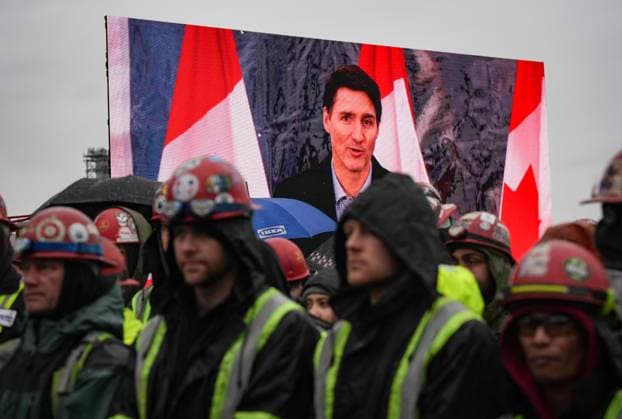 December 13, 2024, North Vancouver, Bc, CANADA: Prime Minister Justin Trudeau is seen on a video screen while speaking as workers listen during a launch and naming ceremony for the new Royal Canadian Navy Joint Support vessel HMCS Protecteur, at Seaspan Shipyards in North Vancouver, B.C., on Friday, December 13, 2024. The ship is scheduled to be delivered to the Royal Canadian Navy in 2025. North Vancouver CANADA  - ZUMAc35_ 20241213_zaf_c35_098 Copyright: xDarrylxDyckx