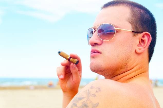 man on beach handsome man with cigar on beach is looking sideways ,model released, Symbolfoto Copyright: xZoonar.com SergeyxPetermanx 3129333 ,model released, Symbolfoto ,property released
