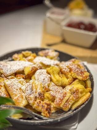 Famous Austrian sweet dish Kaiserschmarrn Famous Austrian sweet dish Kaiserschmarrn served in a pan with ice cream, raspberry and stewed plums Copyright: xZoonar.com FabianxMesebergx 22513384