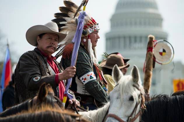 Keystone Pipeline Protest UNITED STATES - APRIL 22: Indigenous leaders from the Cowboy and Indian Alliance watch form their horses as tribal leaders host a traditional opening ceremony to begin their ride from the Capitol to their camp on the National Mall to protest The Kesystone XL Pipeline on Tuesday, April 22, 2014. 24 ranchers and indigenous leaders from the Cowboy and Indian Alliance rode their horses from the Capitol to the Reject and Protect encampment on the National Mall for a weekÕs worth of ÒReject and ProtectÓ actions against the Keystone XL tar sands pipeline. (Photo By Bill Clark CQ Roll Call) Washington DC United States EDITORIAL USE ONLY Copyright: x x2014xCQ-RollxCall,xInc.x BillxClarkx rollcallpix083345