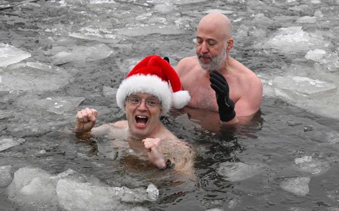 January 1, 2025, Quebec, Pq, Canada: Local resident Simon Plourde reacts to his first swim into the icy water of the St.Lawrence river for a Polar Bear swim on New Year s Day in Quebec City, Wednesday, Jan. 1, 2025. Organizer Francis Vachon is seen at right. Quebec Canada  - ZUMAc35_ 20250101_zaf_c35_006 Copyright: xJacquesxBoissinotx