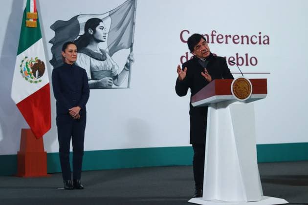 Mexico s President Claudia Sheinbaum, is seen behind while JesoÂºs RamoÂ­rez Cuevas, Coordinator of Advisors to the Presidency of Mexico speaking during a briefing conference about the National Development Plan, which defines the economic, social and political priorities for the six-year term, and the evolution of the price of regular gasoline at the National Palace. on January 3, 2024 in Mexico City, Mexico. Mexico City Mexico - ZUMAe321 20250103_zia_e321_004 Copyright: xCarlosxSantiagox