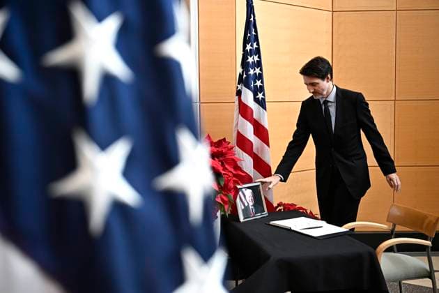 January 3, 2025, Ottawa, On, CAN: Prime Minister Justin Trudeau touches a photo of former U.S. President Jimmy Carter after signing a book of condolences at the U.S. Embassy in Ottawa, on Friday, Jan. 3, 2025. Ottawa CAN  - ZUMAc35_ 20250103_zaf_c35_022 Copyright: xJustinxTangx