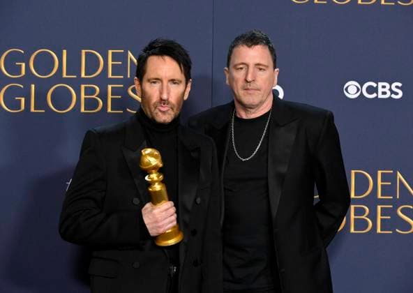 (L-R) Trent Reznor and Atticus Ross, winners of the Best Original Score - Motion Picture award for Challengers, appear backstage during the 82nd annual Golden Globe Awards at the Beverly Hilton Hotel in Beverly Hills, California on Sunday, January 5, 2025.  LAP20250105474 JIMxRUYMEN