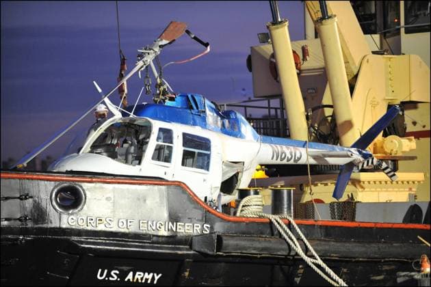 Manhattan chopper down October 4, 2011, New York, New York, USA: Just after 3PM, a helicopter with four British tourists and the pilot went down into East River by the 34th Street heliport. Four people were pulled out, one female was DOA ( dead on arrival ) and pulled out of the chopper which sank in the East River about 90 minutes later. The cause of the accident is unknown. Manhattan, New York, Tuesday, October 4th 2011. Damaged helicopter salvaged. Credit: Paul Martinka Polaris New York USA  Copyright: xPaulxMartinkax