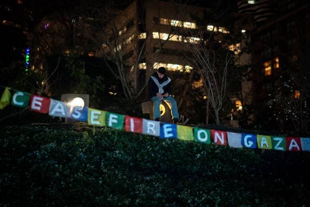 January 15, 2025, Vancouver, Bc, CANADA: A person sits during a gathering to celebrate the Gaza ceasefire and hostage deal reached between Israel and Hamas in Vancouver, on Wednesday, January 15, 2025. Vancouver CANADA  - ZUMAc35_ 20250115_zaf_c35_227 Copyright: xEthanxCairnsx