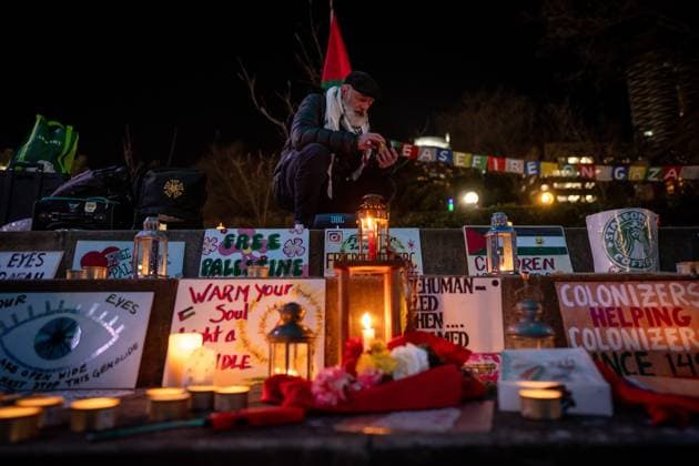 January 15, 2025, Vancouver, Bc, CANADA: A man sets up signs and candles during a gathering to celebrate the Gaza ceasefire and hostage deal reached between Israel and Hamas in Vancouver, on Wednesday, January 15, 2025. Vancouver CANADA  - ZUMAc35_ 20250115_zaf_c35_230 Copyright: xEthanxCairnsx