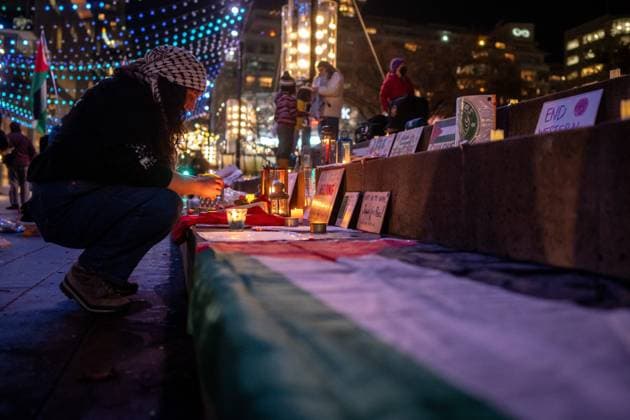 January 15, 2025, Vancouver, Bc, CANADA: A person sets up candles before a gathering to celebrate the Gaza ceasefire and hostage deal reached between Israel and Hamas in Vancouver, on Wednesday, January 15, 2025. Vancouver CANADA  - ZUMAc35_ 20250115_zaf_c35_231 Copyright: xEthanxCairnsx