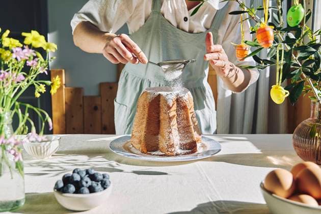 Woman sifting icing sugar on Pandoro bread model released, Symbolfoto property released, CATF00574