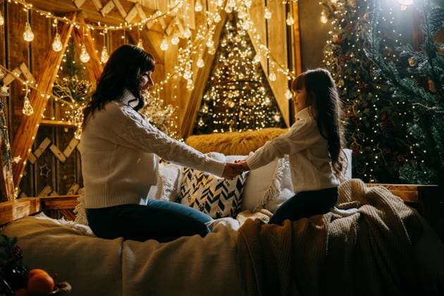 A little girl with her mother in a cozy home environment on the sofa next to the Christmas tree. The theme of New Year holidays and festive interior with garlands and light bulbs., model released, , 49075114.jpg, baby, background, beautiful, bright, bulbs, celebrate, celebration, celebration event, child, Christmas, christmas gifts, christmas toy, concept, cozy, curly hair, cute, decoration, environment, festive, garland, garlands, girl, glistering, glitter, hands, happiness, happy, her, holiday, holidays, home, interior, light, lights, little, magic, memory, moment, mother, New, new year, next, party, shiny, smile, sofa, theme, tree, winter, Year RECORD DATE NOT STATED