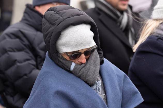January 27, 2025, Ottawa, On, Canada: A person huddles to stay warm as they listen to speakers during a ceremony at the National Holocaust Monument, Monday, Jan 27, 2025 in Ottawa. Ottawa Canada  - ZUMAc35_ 20250127_zaf_c35_052 Copyright: xAdrianxWyldx