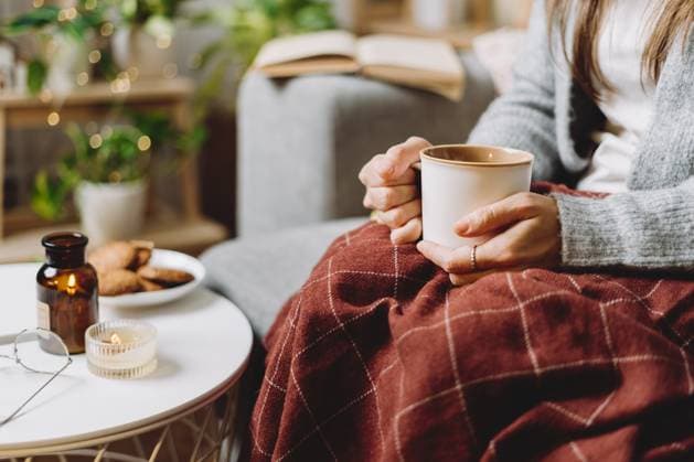 Cozy woman legs in knitted winter warm sweater and checkered plaid drinking hot cocoa or coffee in mug, sitting on couch at home. Autumn vibes with candle, decor, cookies and indoor plants , 49160360.jpg, woman, cozy, home, holidays, winter, leg, mug, plaid, relaxing, warm, indoor, cocoa, decoration, cosy, female, comfort, knitted, season, book, hot, december, cup, snug, heat, plants, rest, blanket, foot, candle, pajama, lights, autumn, leisure, coffee, enjoying, hygge, sweater, wool, sitting, domestic life, home interior, couch, bed, drink, lifestyle, people, tea, soft, hands RECORD DATE NOT STATED
