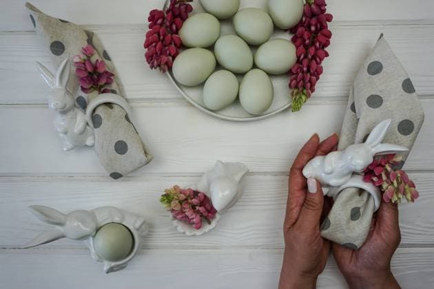 Women s hands decorate a napkin for the Easter table. There are Easter eggs in the plate. , 49195980.jpg, background, decoration, easter, concept, egg, holiday, spring, food, napkin, rabbit, table, rustic, celebration, dinner, festive, happy, flowers, handmade, cutlery, serving, tradition, traditional, natural, beautiful, dining, event, symbol, flower, seasonal, elegant, greeting, pastel, decor, design, stylish, eggs, religion, flat coating, pink, vintage, wooden, colorful, season, tablecloth, service, table top, easter eggs, nature, plant, breakfast RECORD DATE NOT STATED