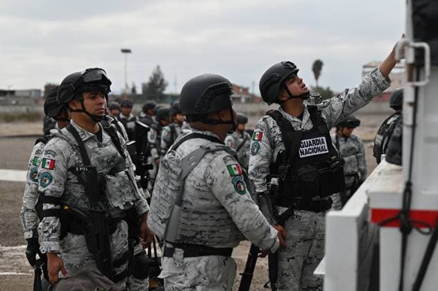 February 4, 2025, Tijuana, Baja California, Mexico: Members of the Mexican National Guard arrive at Military Air Base No. 12 near the Tijuana International Airport in Tijuana, Baja California, Mexico, on Tuesday, February 04, 2025. The arrival of Mexicoâ€⠢s first 300 officers in the border city begins the 10,000 troop deployment President Claudia Sheinbaum had promised US President Donald Trump in exchange for delaying a 25-percent tariff on exported goods for a month with future negotiations to be determined. Tijuana Mexico - ZUMAm180 20250204_zip_m180_006 Copyright: xCarlosxA.xMorenox