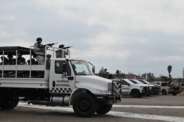 February 4, 2025, Tijuana, Baja California, Mexico: Members of the Mexican National Guard arrive at Military Air Base No. 12 near the Tijuana International Airport in Tijuana, Baja California, Mexico, on Tuesday, February 04, 2025. The arrival of Mexicoâ€⠢s first 300 officers in the border city begins the 10,000 troop deployment President Claudia Sheinbaum had promised US President Donald Trump in exchange for delaying a 25-percent tariff on exported goods for a month with future negotiations to be determined. Tijuana Mexico - ZUMAm180 20250204_zip_m180_007 Copyright: xCarlosxA.xMorenox