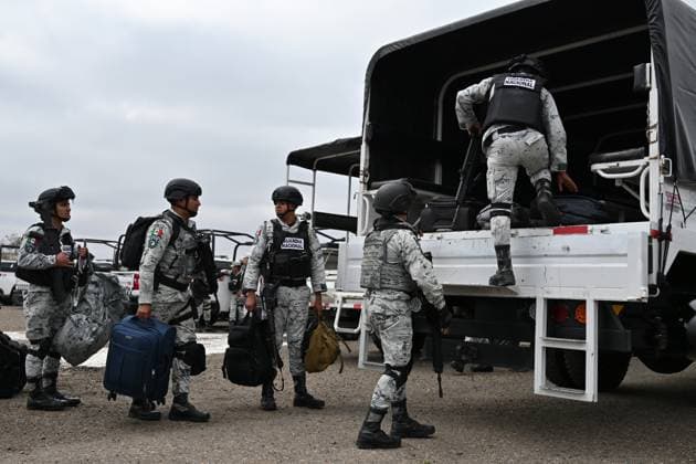 February 4, 2025, Tijuana, Baja California, Mexico: Members of the Mexican National Guard arrive at Military Air Base No. 12 near the Tijuana International Airport in Tijuana, Baja California, Mexico, on Tuesday, February 04, 2025. The arrival of Mexicoâ€⠢s first 300 officers in the border city begins the 10,000 troop deployment President Claudia Sheinbaum had promised US President Donald Trump in exchange for delaying a 25-percent tariff on exported goods for a month with future negotiations to be determined. Tijuana Mexico - ZUMAm180 20250204_zip_m180_001 Copyright: xCarlosxA.xMorenox
