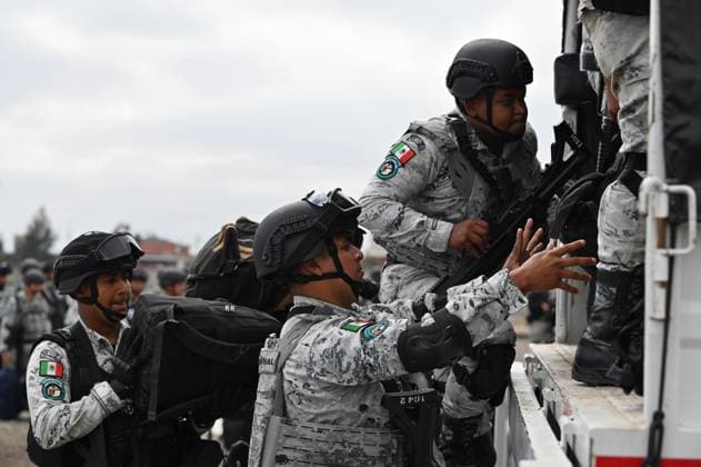 February 4, 2025, Tijuana, Baja California, Mexico: Members of the Mexican National Guard arrive at Military Air Base No. 12 near the Tijuana International Airport in Tijuana, Baja California, Mexico, on Tuesday, February 04, 2025. The arrival of Mexicoâ€⠢s first 300 officers in the border city begins the 10,000 troop deployment President Claudia Sheinbaum had promised US President Donald Trump in exchange for delaying a 25-percent tariff on exported goods for a month with future negotiations to be determined. Tijuana Mexico - ZUMAm180 20250204_zip_m180_026 Copyright: xCarlosxA.xMorenox