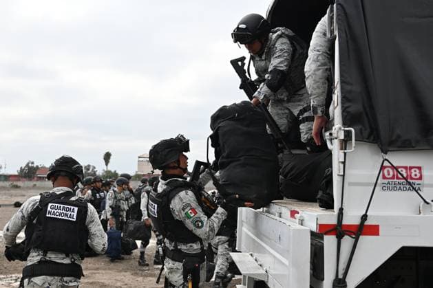 February 4, 2025, Tijuana, Baja California, Mexico: Members of the Mexican National Guard arrive at Military Air Base No. 12 near the Tijuana International Airport in Tijuana, Baja California, Mexico, on Tuesday, February 04, 2025. The arrival of Mexicoâ€⠢s first 300 officers in the border city begins the 10,000 troop deployment President Claudia Sheinbaum had promised US President Donald Trump in exchange for delaying a 25-percent tariff on exported goods for a month with future negotiations to be determined. Tijuana Mexico - ZUMAm180 20250204_zip_m180_009 Copyright: xCarlosxA.xMorenox