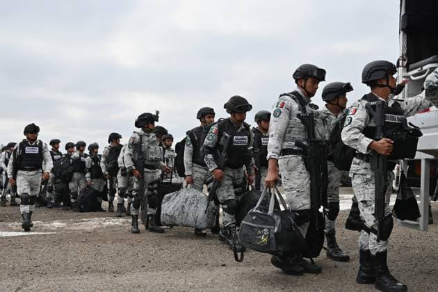 February 4, 2025, Tijuana, Baja California, Mexico: Members of the Mexican National Guard arrive at Military Air Base No. 12 near the Tijuana International Airport in Tijuana, Baja California, Mexico, on Tuesday, February 04, 2025. The arrival of Mexicoâ€⠢s first 300 officers in the border city begins the 10,000 troop deployment President Claudia Sheinbaum had promised US President Donald Trump in exchange for delaying a 25-percent tariff on exported goods for a month with future negotiations to be determined. Tijuana Mexico - ZUMAm180 20250204_zip_m180_013 Copyright: xCarlosxA.xMorenox