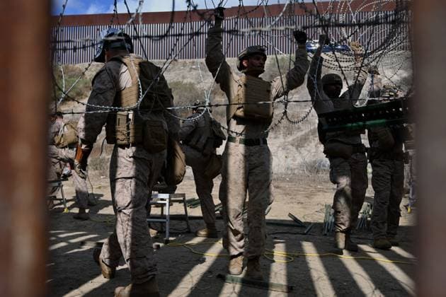 February 6, 2025, Tijuana, Baja California, Mexico: Members of the US Marine Corps install concertina wire along the US-Mexico border wall in San Diego, California, seen from Tijuana, Mexico in between the San Diego-Tijuana border fences of Colonia Libertad on Thursday, February 06, 2025. The Defense Department deployed 1,600 active-duty troops to the border during US President Donald Trumpâ€⠢s first week in office. Tijuana Mexico - ZUMAm180 20250206_zip_m180_005 Copyright: xCarlosxA.xMorenox