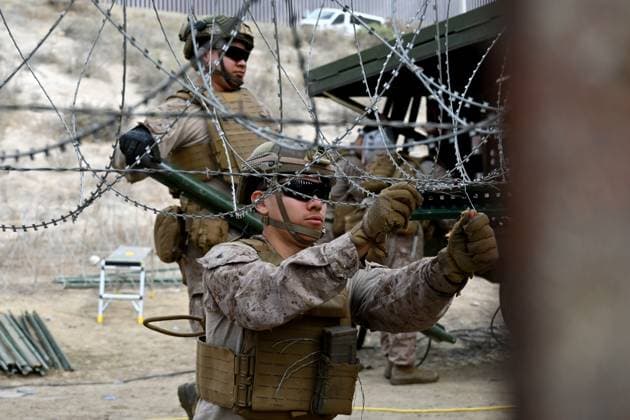 February 6, 2025, Tijuana, Baja California, Mexico: Members of the US Marine Corps install concertina wire along the US-Mexico border wall in San Diego, California, seen from Tijuana, Mexico in between the San Diego-Tijuana border fences of Colonia Libertad on Thursday, February 06, 2025. The Defense Department deployed 1,600 active-duty troops to the border during US President Donald Trumpâ€⠢s first week in office. Tijuana Mexico - ZUMAm180 20250206_zip_m180_006 Copyright: xCarlosxA.xMorenox